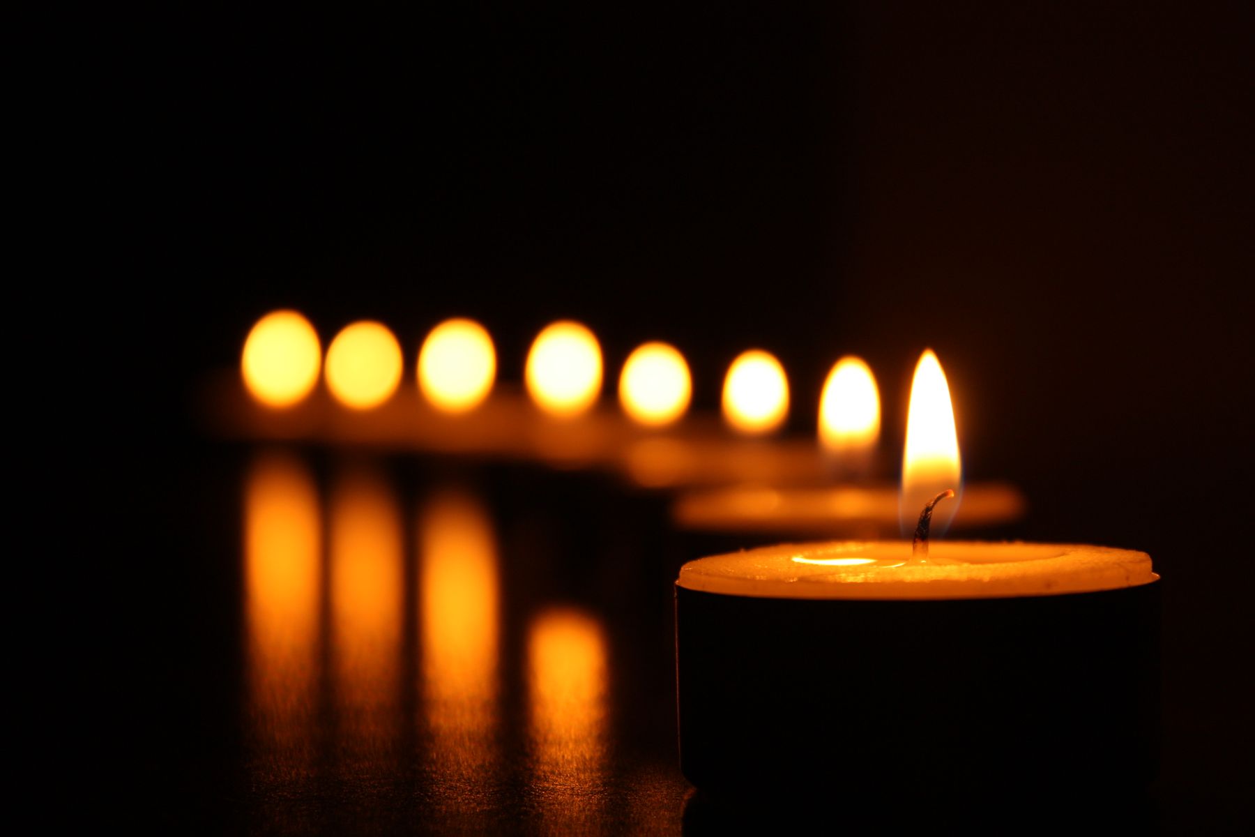 Many lit candles in a warm atmosphere
