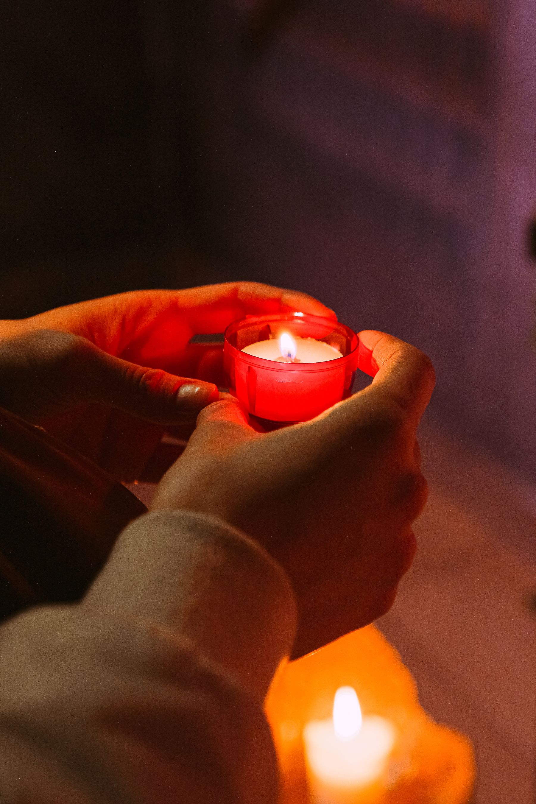 A candle held in a calm spiritual atmosphere